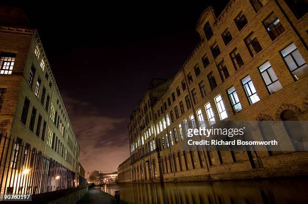 Night view of the mill and the Leeds-Liverpool canal. The mill was built on the bank of the River Aire near Shipley by philanthropic mill owner Sir...