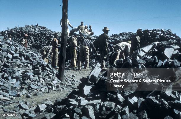 Photograph from the collection of pathologist Dr J C Wagner showing men surrounded by blue asbestos rocks in a mine near Prieska, South Africa....