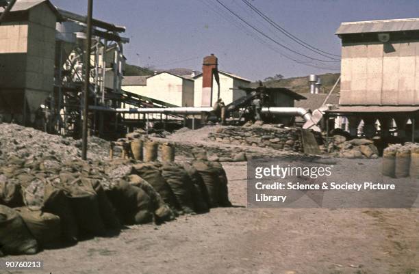 Photograph from the collection of pathologist Dr J C Wagner showing the asbestos mill at Penge, South Africa. The blue asbestos rocks were crushed at...