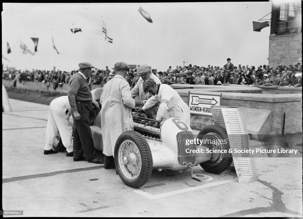 Mechanics working on a Mercedes-Benz, German Grand Prix, Nurburgring, 1934.