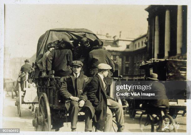 Men riding on the back of a horse-drawn cart. Photograph from an album compiled at the time of the General Strike in 1926.