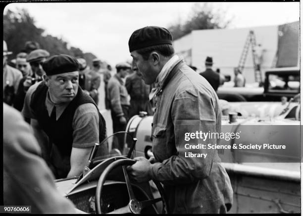 Veyron talking to his mechanic Robert Aumaitre. French Grand Prix motor racing driver Veyron won the 24 Hours of Le Mans in 1939. The Bugatti Veyron...