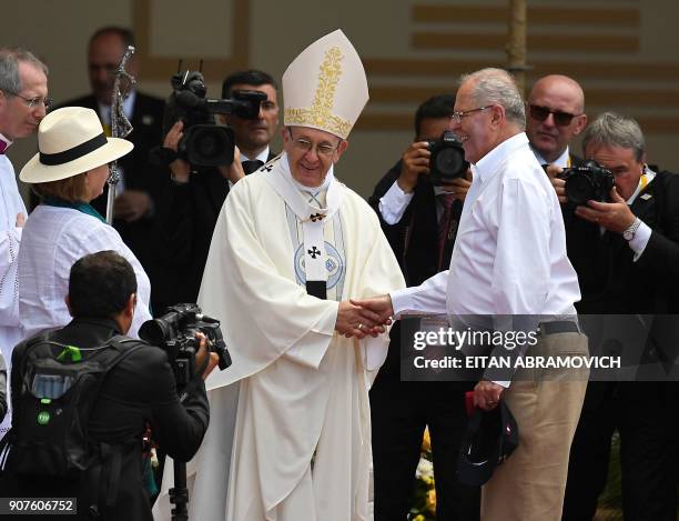 Pope Francis greets Peruvian President Pedro Pablo Kuczynski at an open-air mass at the beach resort town of Huanchaco, northwest of the Peruvian...