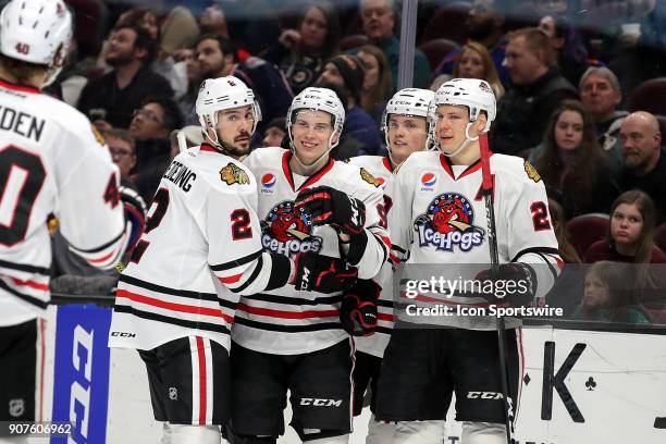 Rockford IceHogs left wing Matthew Highmore is congratulated by Rockford IceHogs defenceman Adam Clendening , Rockford IceHogs center Luke Johnson ,...