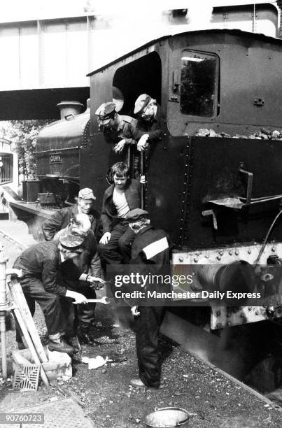Train �nuts� messing about with a steam locomotive: Ian Hurst, deputy general manager on leave from Barclay DCO ; Norman Reeves, a plumber from...
