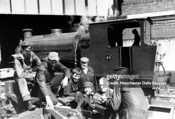 Train �nuts� messing about with a steam locomotive: Ian Hurst, deputy general manager on leave from Barclay DCO ; Norman Reeves, a plumber from...
