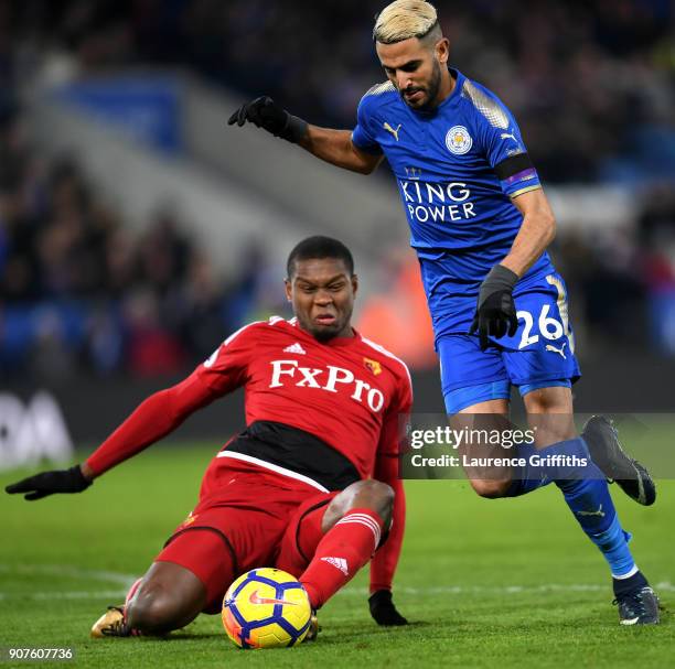 Riyad Mahrez of Leicester City escapes a challenge from Marvin Zeegelaar of Watford on the way to the scoring his siddes first goal during the...