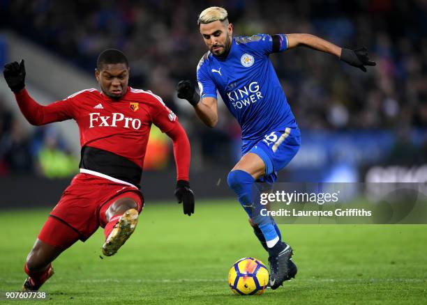 Riyad Mahrez of Leicester City escapes a challenge from Marvin Zeegelaar of Watford on the way to the scoring his siddes first goal during the...