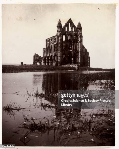 Photograph by Frank Meadow Sutcliffe . The ancient ruins of the Abbey dominate the East Cliff of Whitby and have long been used as a landmark by...