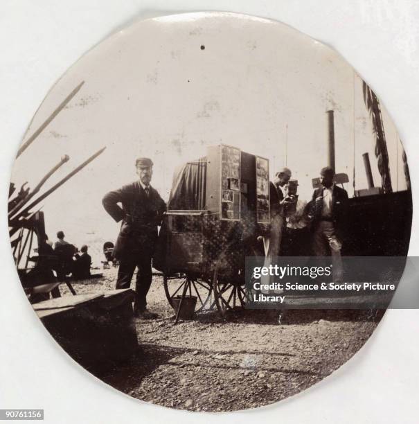 Kodak circular snapshot photograph of a beach photographer with his portable darkroom, taken by an unknown photographer in about 1890. For many years...