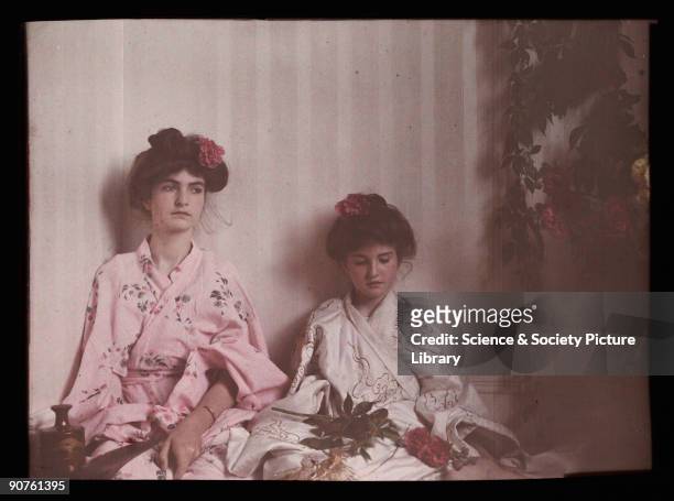 An autochrome of her daughters dressed in Japanese-style outfits, taken by Etheldreda Janet Laing in 1908. They both have flowers in their hair,...