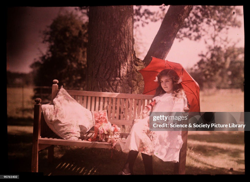 Girl with a parasol sitting on a bench, 1908.