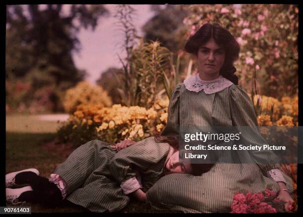 An autochrome of two sisters, daughters of the photographer, together in a garden on a hot summer�s day, taken by Etheldreda Janet Laing. The younger...
