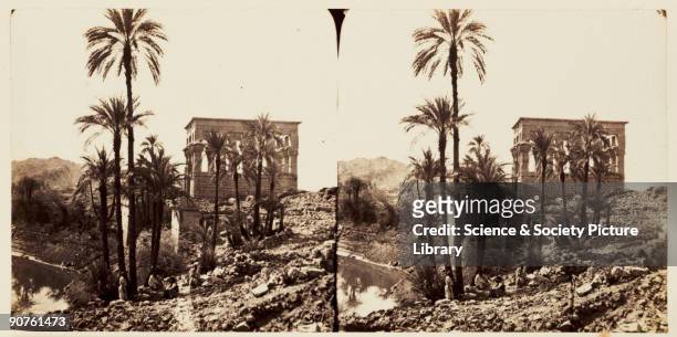 Stereoscopic photograph of the small temple of Hathor seen beyond palm trees on the island of Philae, Aswan, Egypt, taken in 1859 by Francis Frith ....