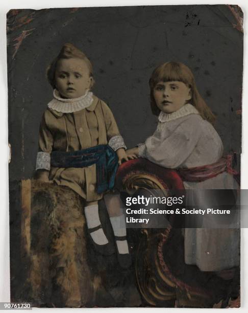 Hand-coloured tintype photograph of a young boy and girl, taken by an unknown photographer in about 1880 The Tintype process was a variation of the...