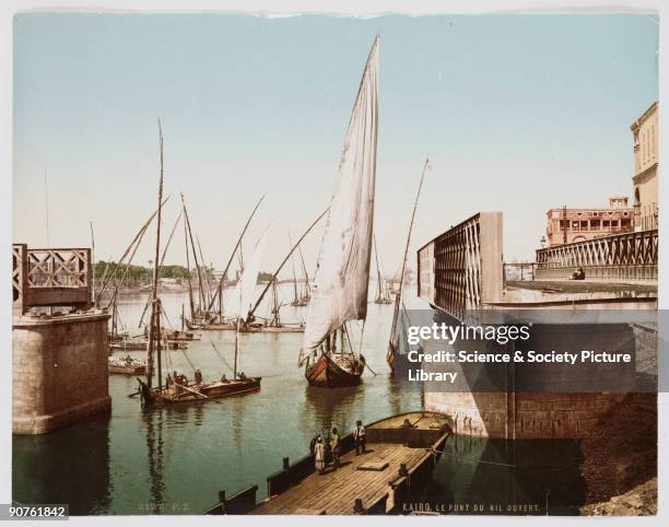 Dhows sailing on the Nile navigate an open swing bridge, near Cairo in Egypt. From a collection of photographs, equipment and printed material...