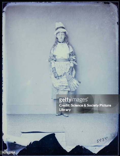 Xie was the daughter of the Reverend George William Kitchin, Dean of Winchester and later of Durham. She is standing in costume, wearing lace gloves,...