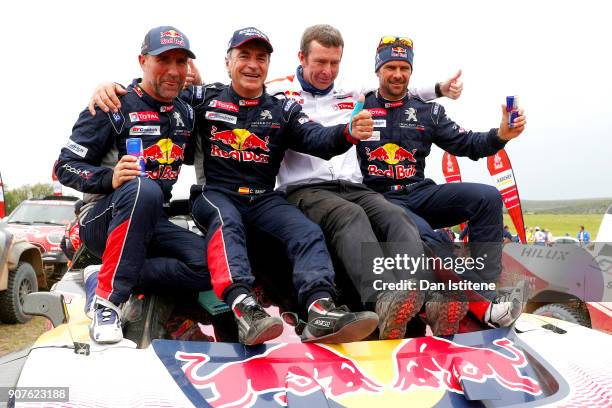 Carlos Sainz of Spain and Peugeot Total celebrates victory with team-mates Stephane Peterhansel of France and Peugeot Total, Cyril Despres of France...