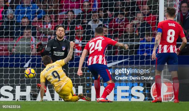 Cristian ÔPortu' Portugues of Gerona beats Jan Oblak of Atletico de Madrid to score his team's opening goal during the La Liga match between Atletico...