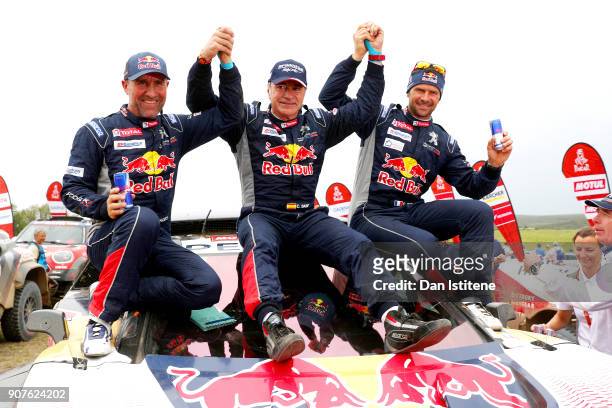 Carlos Sainz of Spain and Peugeot Total celebrates victory with team-mates Stephane Peterhansel of France and Peugeot Totaland Cyril Despres of...