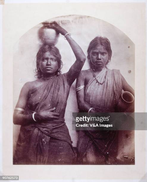 Three quarter length portrait of two women from Ceylon holding pots, by Julia Margaret Cameron . Cameron's photographic portraits are considered...