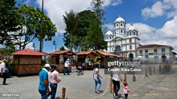 Main square with the Church Parroquia Inmaculada Concepcion on the background. The town of Filandia, currently known as 'La Colina Iluminada de los...