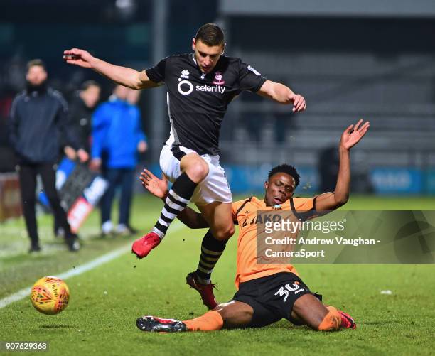 Lincoln City's James Wilson vies for possession with Barnet's Justin Amaluzor during the Sky Bet League Two match between Barnet and Lincoln City at...