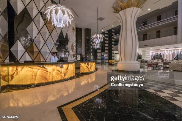 lobby entrance with reception desk and lounge area - lobby stock pictures, royalty-free photos & images