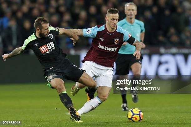 Bournemouth's English defender Steve Cook vies with West Ham United's Austrian midfielder Marko Arnautovic during the English Premier League football...