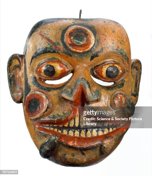 Sinhalese carved and polychrome painted wooden face mask, representing Hevaya, the soldier from the kolam play, his face covered with sores and...