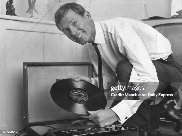 Glasgow Rangers player Ferguson putting on a record by Ray Conniff and his orchestra. Scottish footballer Ferguson played for St Johnstone,...