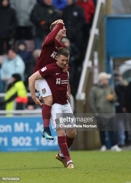 Chris Long of Northampton Town celebrates with team mate Sam Hoskins after scoring his sides second goal during the Sky Bet League One match between...