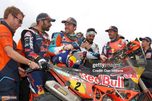 Matthias Walkner of Austria and Red Bull KTM celebrates victory with team-mates Antoine Meo of France and Red Bull KTM and Toby Price of Australia...