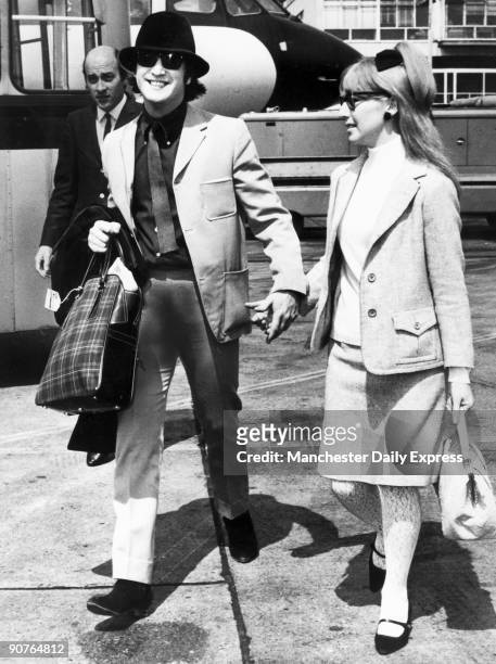 John Lennon and his first wife Cynthia Powell on their way to the Cannes Film Festival. Lennon formed the Beatles in 1960 with Paul McCartney ,...
