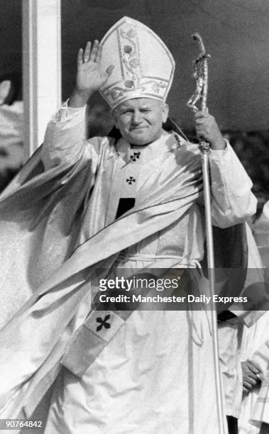 John Paul II , in ceremonial robes, greets the crowd on September 29, 1979.