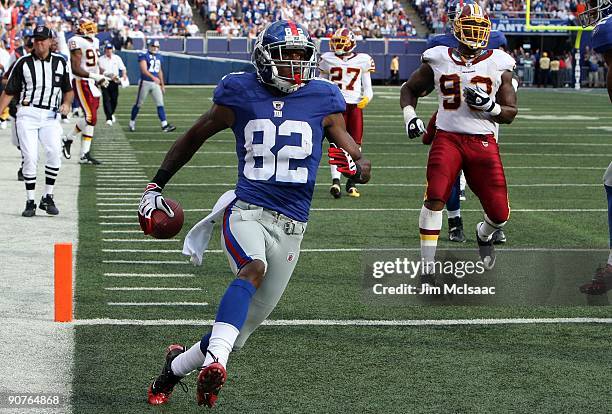 Mario Manningham of the New York Giants runs in a second quarter touchdown against the Washington Redskins on September 13, 2009 at Giants Stadium in...