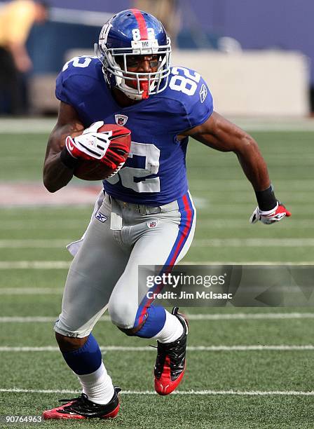 Mario Manningham of the New York Giants runs in a second quarter touchdown against the Washington Redskins on September 13, 2009 at Giants Stadium in...