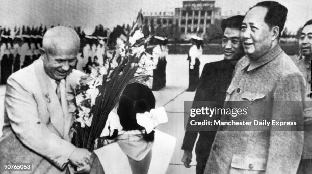 �Thank-you smile from Khrushchev as he receives a bouquet. Watching, in tunic jacket, is Mao Tse-tung�. In 1959 there was a break in relations...