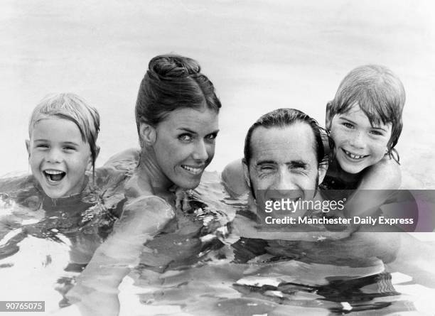 Three times formula one racing champion Jackie Stewart enjoys a swim with his wife Helen and sons Paul and Mark. Stewart first became world champion...