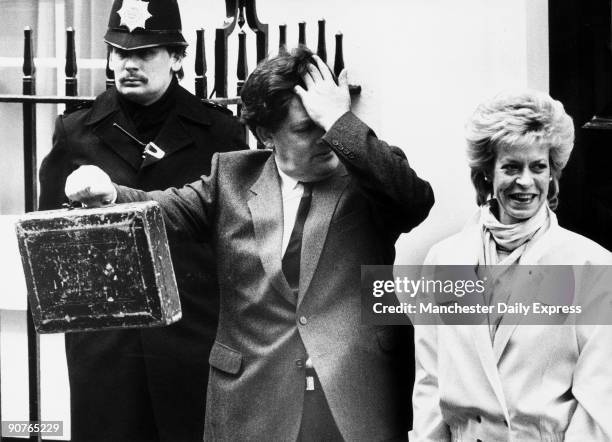 Headache for Lawson�. The chancellor and his wife with the famous red briefcase.