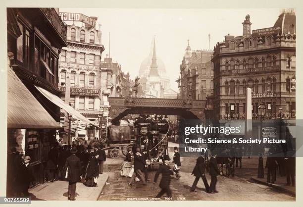 Ludgate Circus, with the �King Lud� pub on the left, a horse-drawn bus the centre and St Paul�s Cathedral in the distance. Photograph from an album...