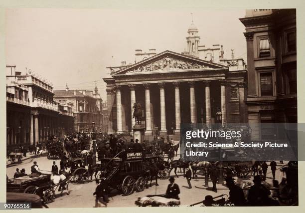 Horse buses in the foreground, with an equestrian statue of the Duke of Wellington outside the Exchange. A photograph from an album of sixty...