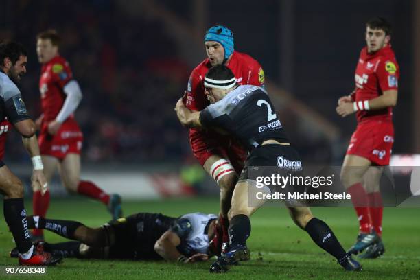 Tadhg Beirne of Scarlets is held up by Guilhem Guirado of Toulon during the European Rugby Champions Cup match between Scarlets and RC Toulon at Parc...