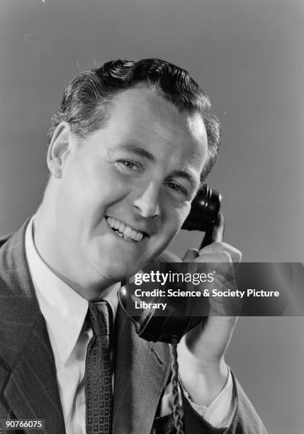 Photograph of a smiling man on the telephone, taken by Photographic Advertising Limited in 1952. Photographic Advertising Limited, founded in 1926,...