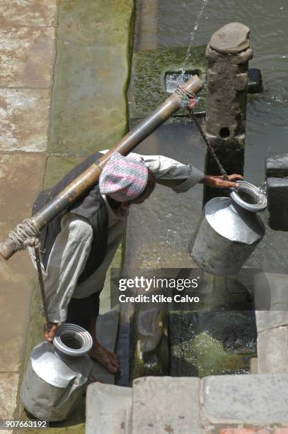 Patan's Durbar Square. Patan. , People collecting water from a public fountain., Sadhu. B1276.