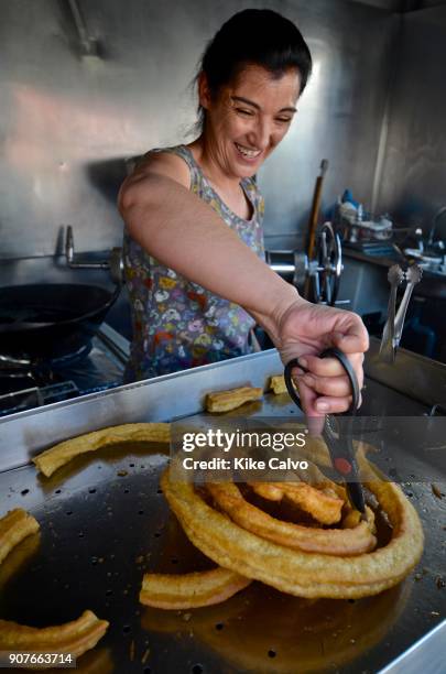 Preparing traditional Spanish churros, a fried-dough pastry.