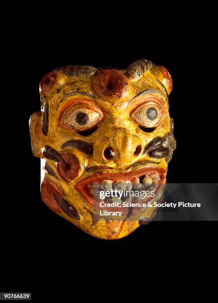 This polychrome wooden mask represents Heraya, the soldier from the kolam play, with his face covered in sores and leeches. It was worn for healing...