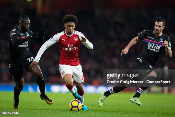 Arsenal's Reiss Nelson beats the challenge of Crystal Palace's Bakary Sako during the Premier League match between Arsenal and Crystal Palace at...