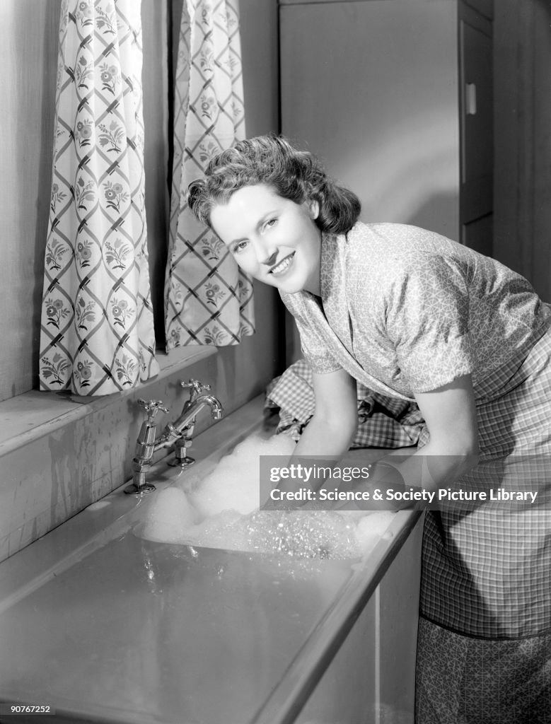 Woman doing the washing up, 1948.