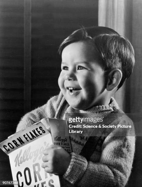 Photograph by Photographic Advertising Limited of a smiling little boy with his hand in a packet of Kellogg's Corn Flakes. Images of children are...